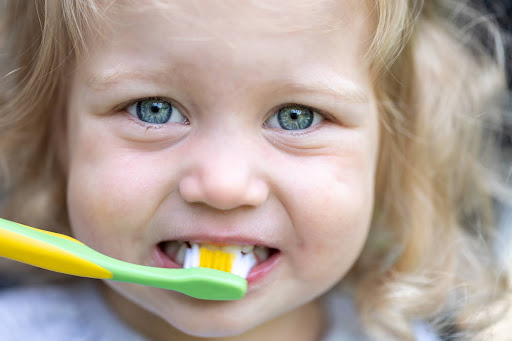 child brushing teeth